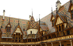 Photograph of the multi-coloured tiled slate roof of the Musee de l’Hotel-Dieu in Beaune, France. Photo taken by Danielle MacDonald